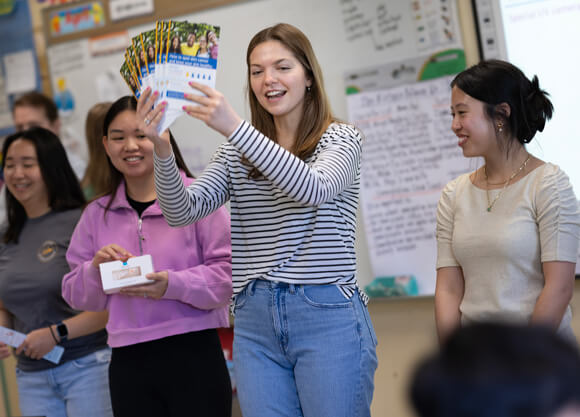 Individual holds up pamflets