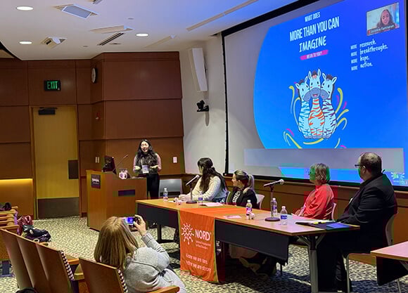 Medical student moderating a conversation with expert panelists
