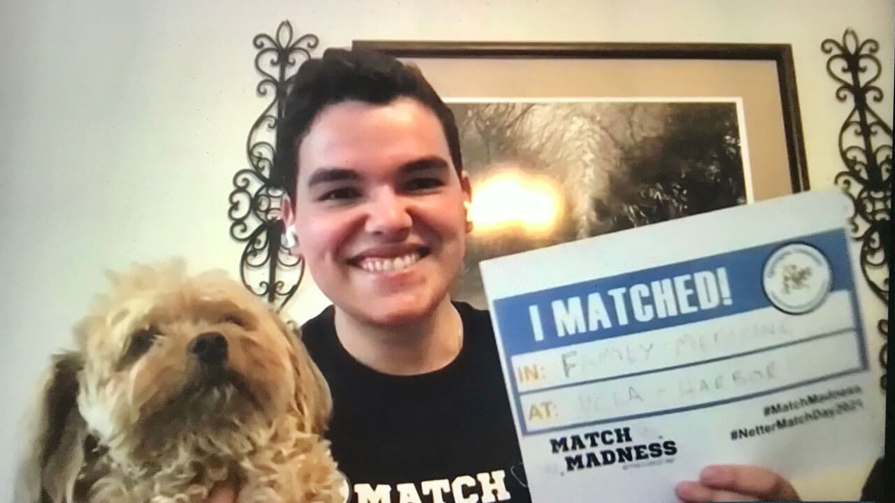 Richard Ferrous celebrates his residency match with his dog