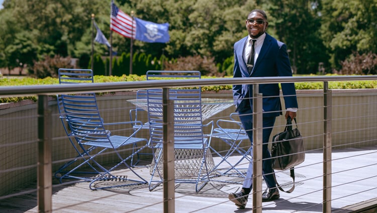 Corey Barron, a Quinnipiac student, walking outside on the North Haven Campus.