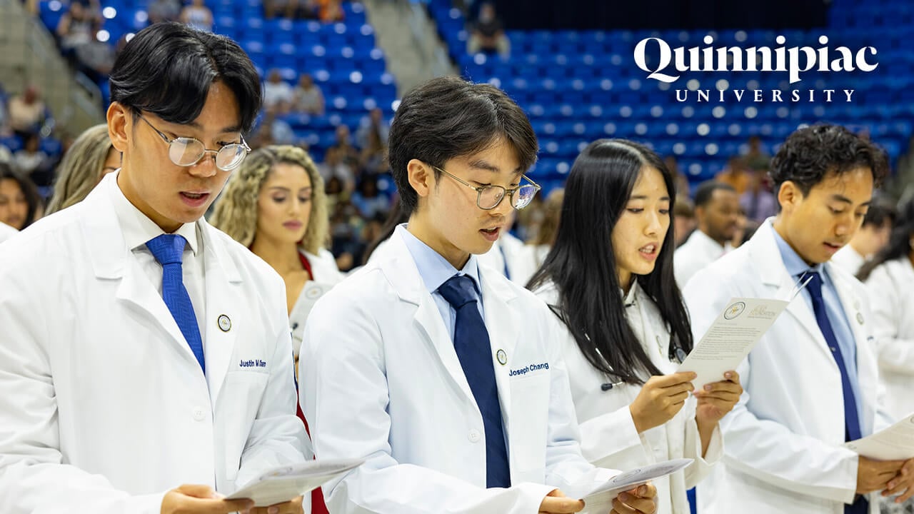 Four School of Medicine students read from the pledge at the White Coat Ceremony.