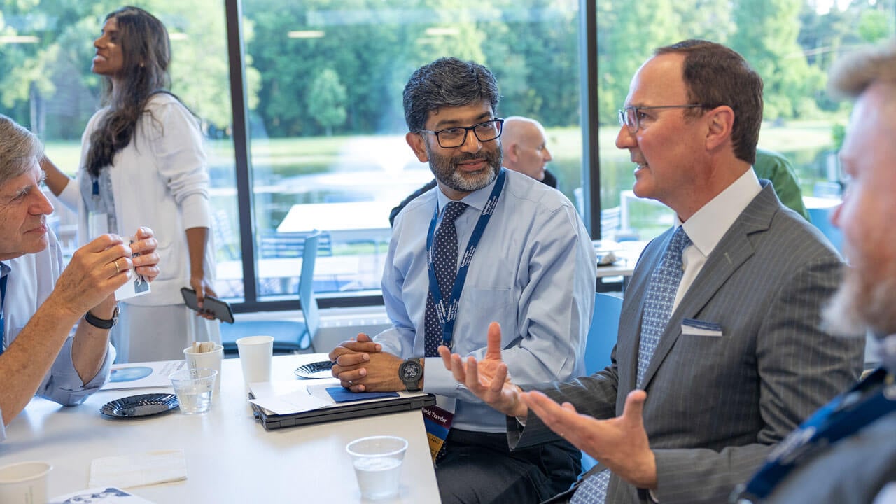 School of Medicine faculty members socialize at an event.