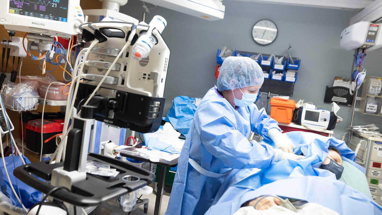 Doctor performs surgery on a patient.